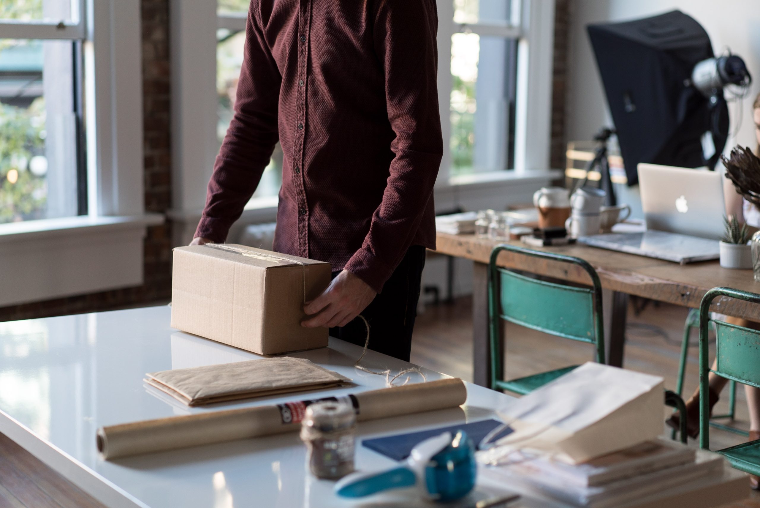 An image of a small business owner preparing a package to ship