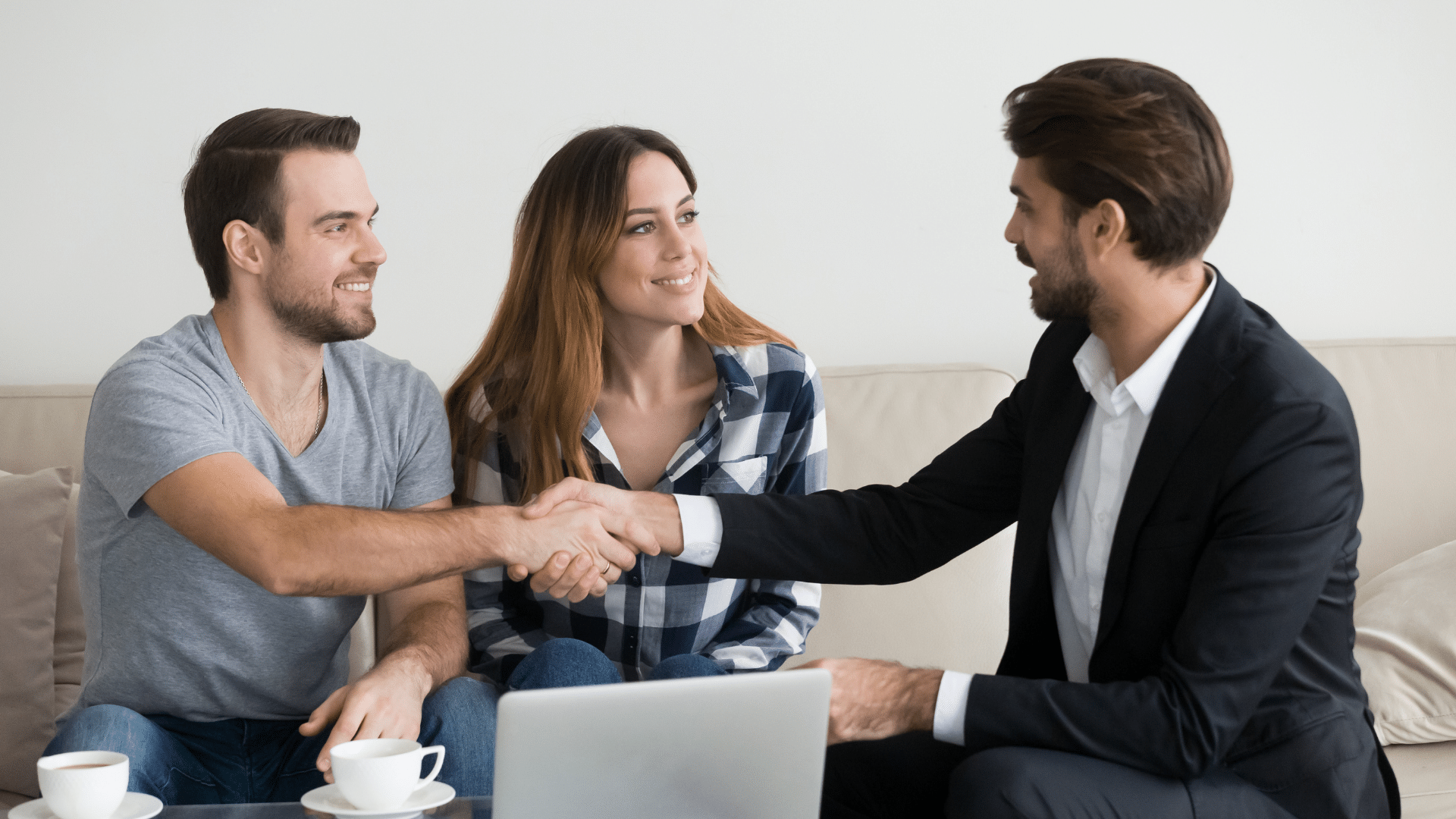 An image of a small business owner and her husband meeting with their business consultant and estate planner.