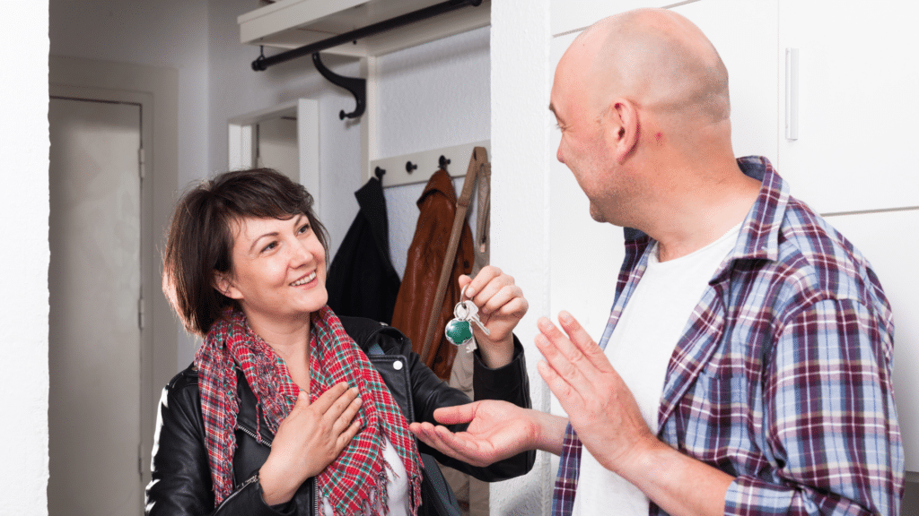 An image of a tenant and a landlord meeting to hand over the keys to the new apartment.