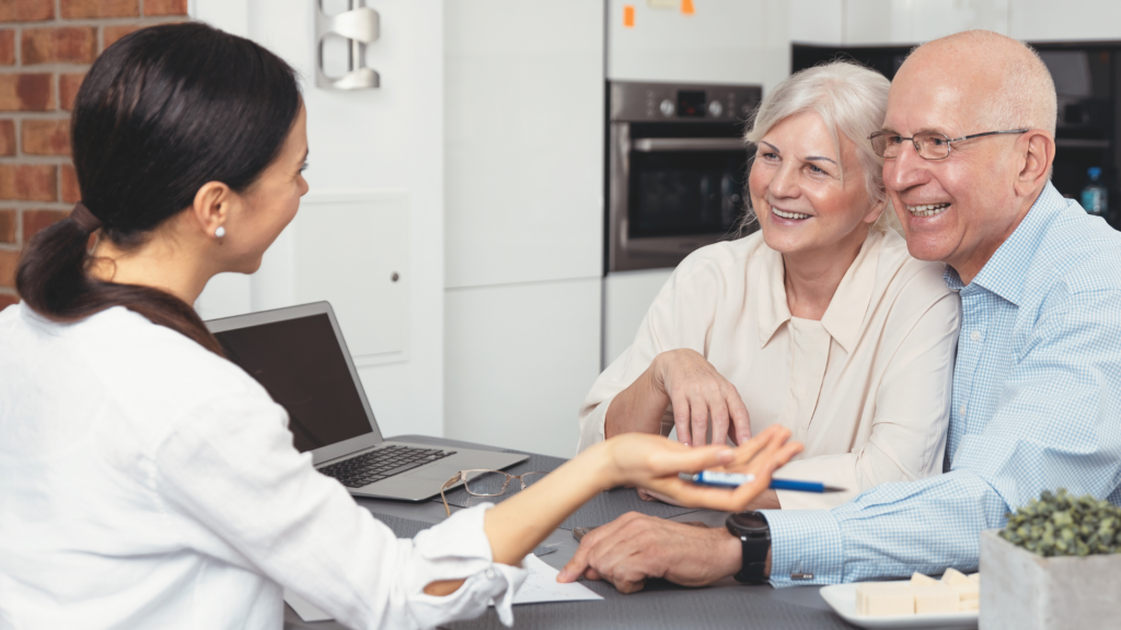 An image of an elderly couple in their home in Oakville where their estate planning advisor is discussing how to best use their Trust