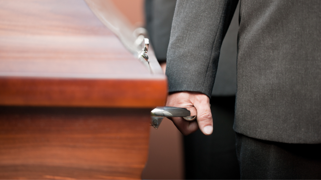 An image of a pallbearer at a funeral in Oakville holding a casket